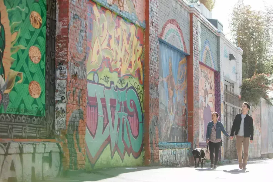 A couple walking down Balmy Alley in the Mission.